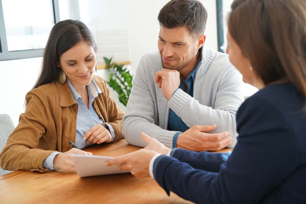 Man and woman talking to a loan officer.