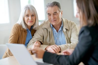 Older couple looking at documents with agent