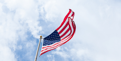 US flag viewed from below against blue sky