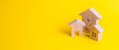 Collection of wooden house ornaments on yellow background